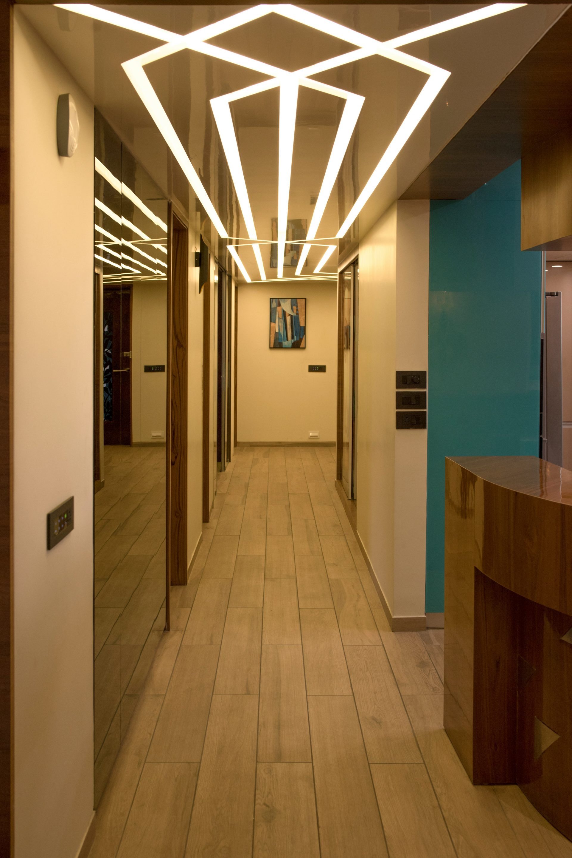 Modern hallway with unique geometric ceiling lighting.